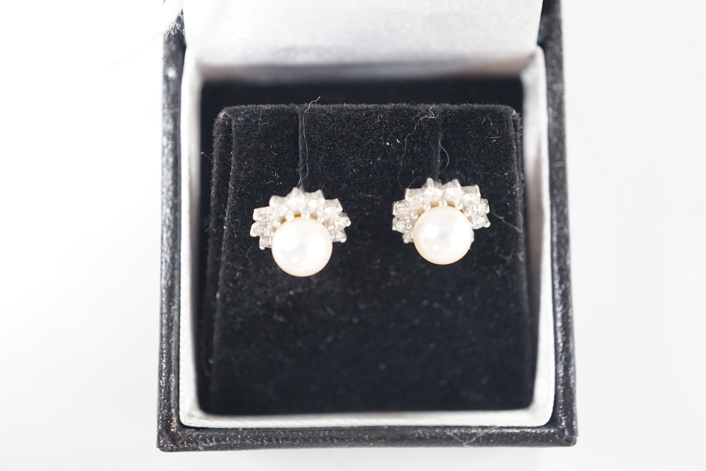 A modern pair of 18ct white gold, cultured pearl and diamond cluster set ear studs, 11mm, gross weight 3 grams.